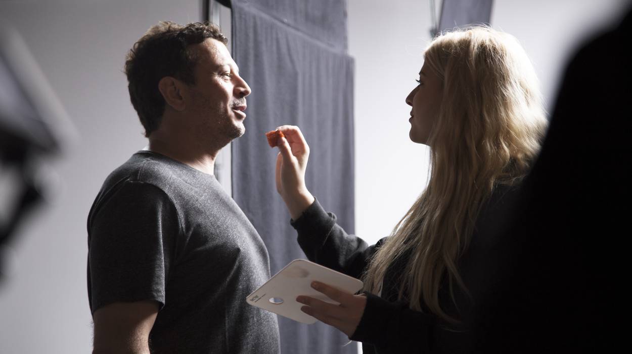 Makeup artist getting touchups done on our lead actor.